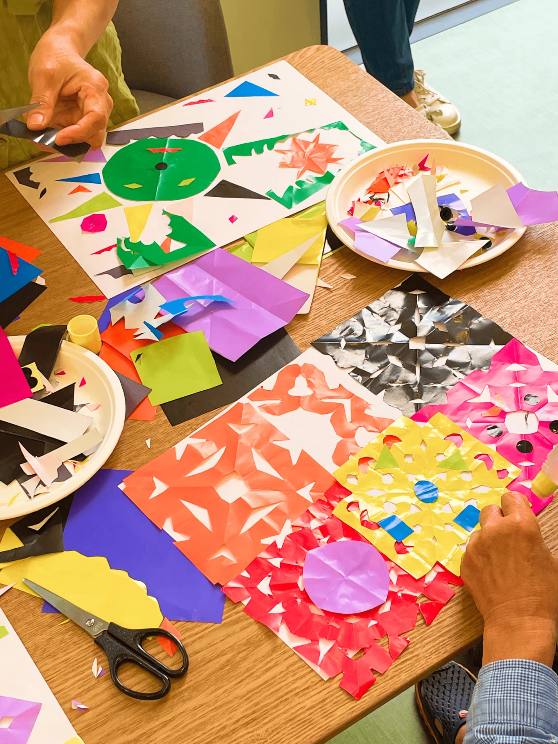 Seniors making paper craft collages